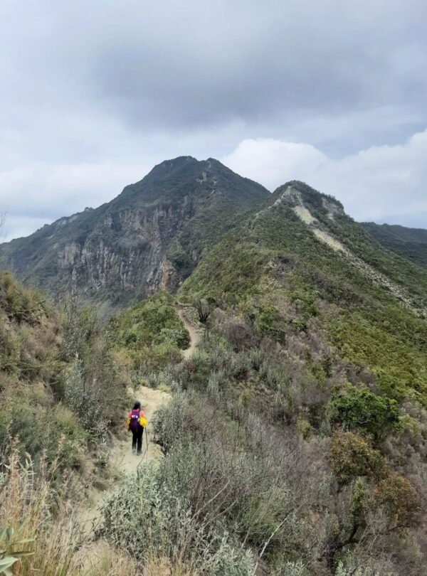 Hiker on the scenic Mt Longonot crater rim trail with dramatic Rift Valley views.