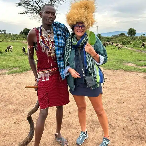Maasai guide standing with a visitor during a cultural experience near Amboseli, showcasing traditional attire and local heritage