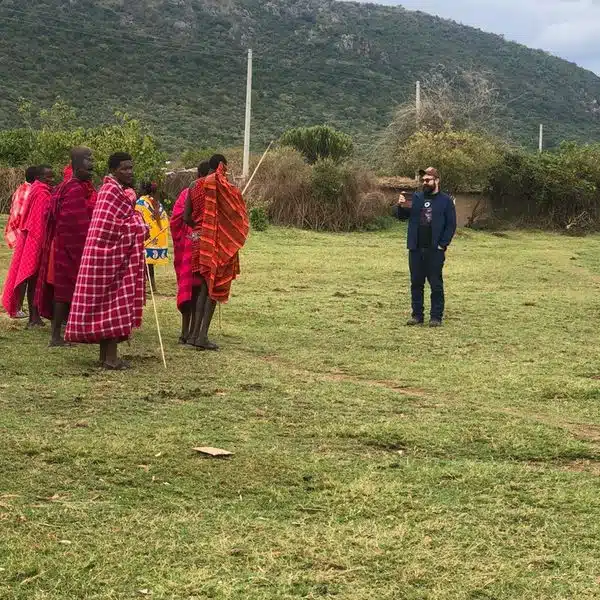 Gemfinders Safaris traveler interacting with Maasai community during village visit in Kenya
