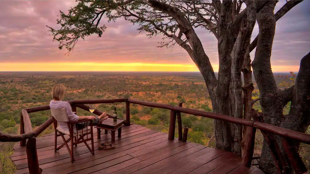 Guest relaxing with sunset views from Elsa’s Kopje luxury lodge in Meru National Park