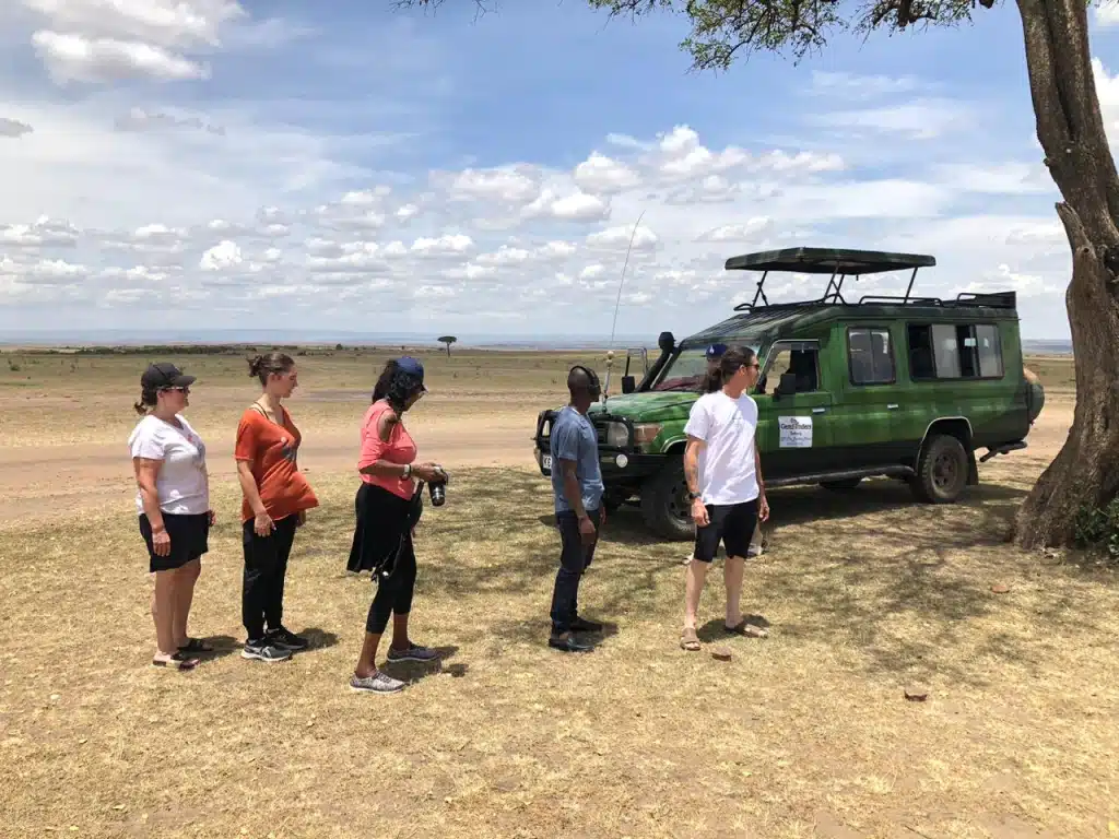 Gemfinders Safaris guests on a private game drive stop in the Masai Mara with 4x4 Landcruiser