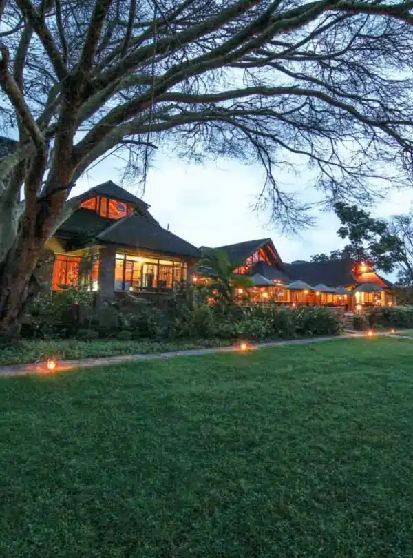 Keekorok Lodge in Masai Mara at dusk with glowing lights and garden view