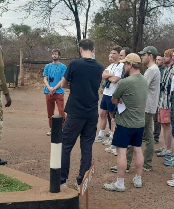 Visitors receiving a ranger briefing at the entrance of Meru National Park before a guided safari experience.