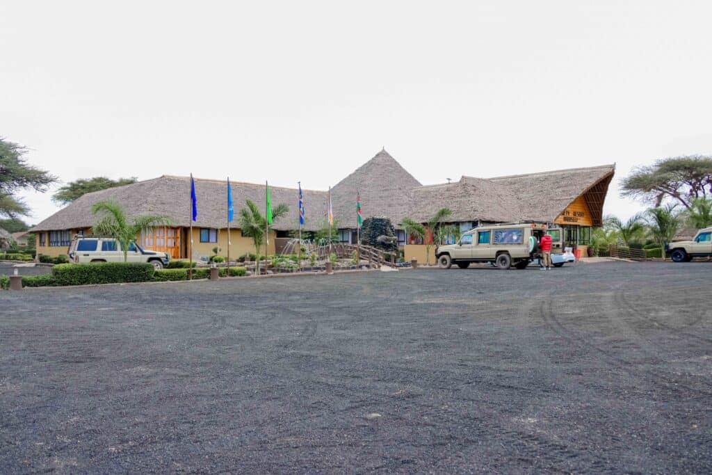 Penety Amboseli Resort exterior with safari Land Cruisers parked outside, a lodge base for a 3 Day Amboseli Safari near Amboseli National Park.