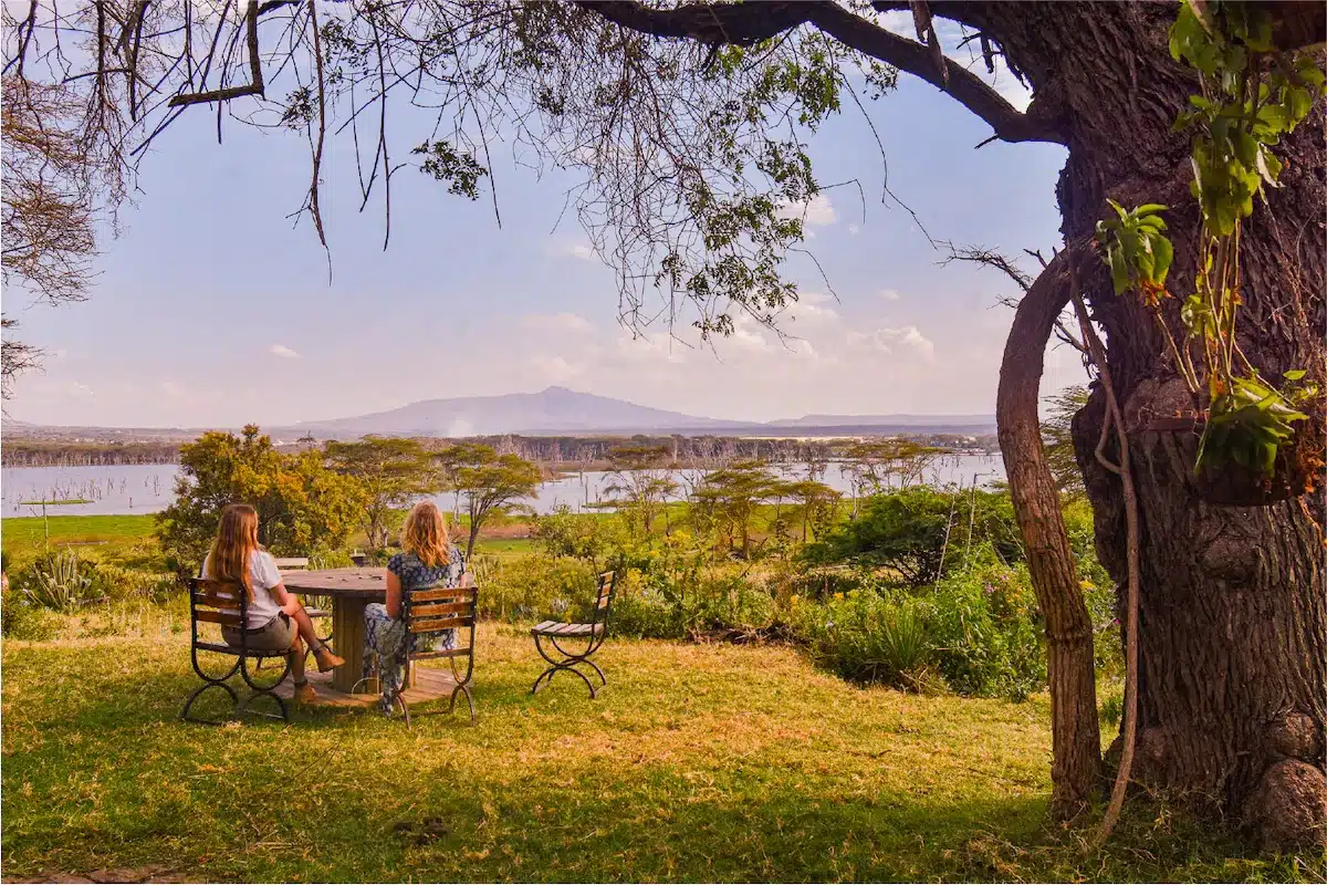 Travelers relaxing with views of Lake Naivasha and Crescent Island during an 8 Day Kenya Safari.