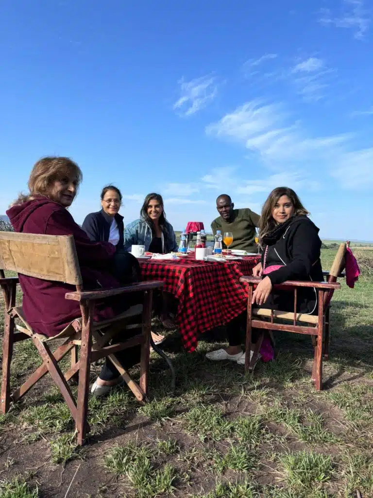 Safari guests enjoying a bush breakfast with their guide during an African safari in Kenya