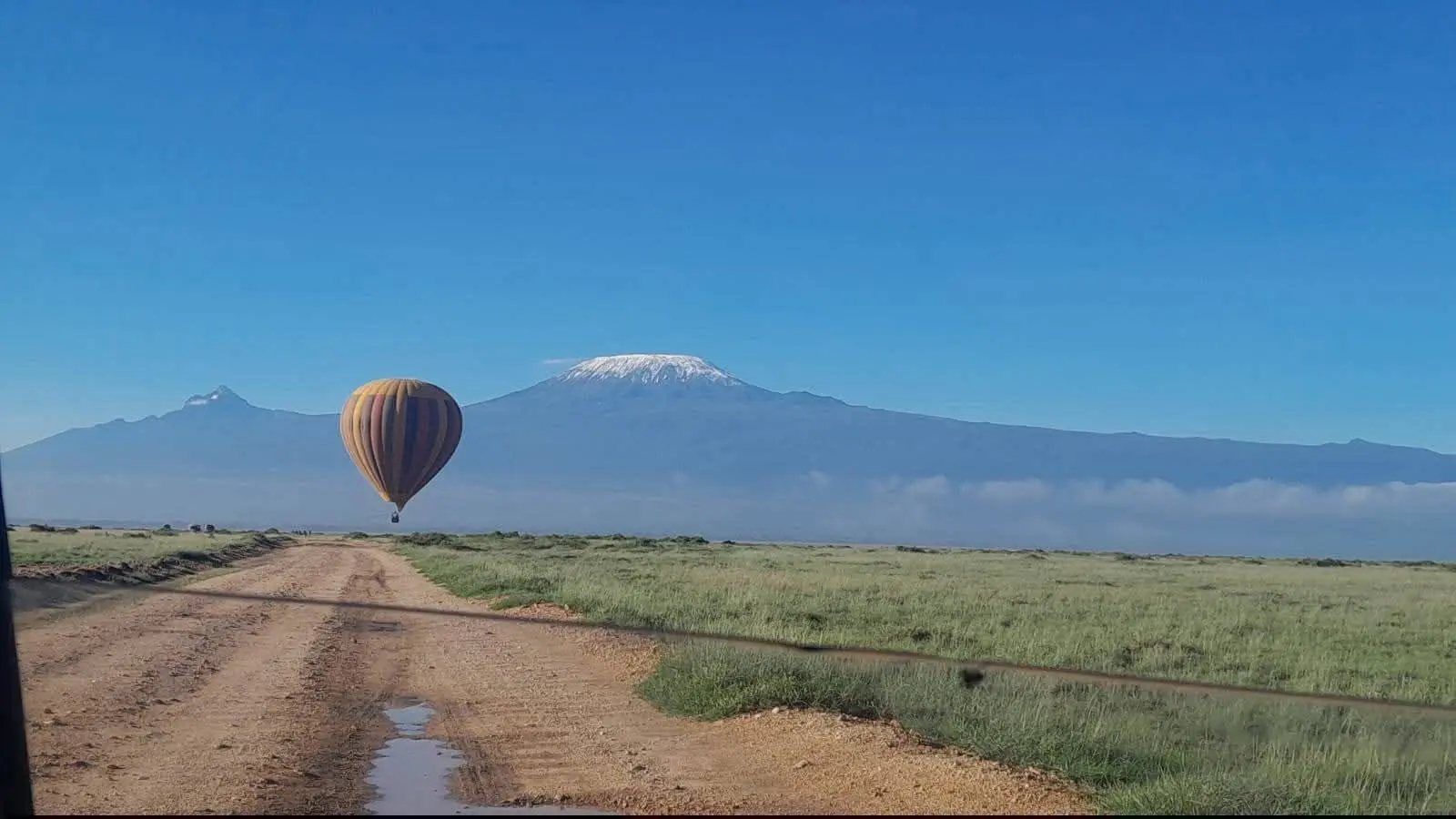 Hot-air balloon flying over Amboseli National Park with Mount Kilimanjaro in the background