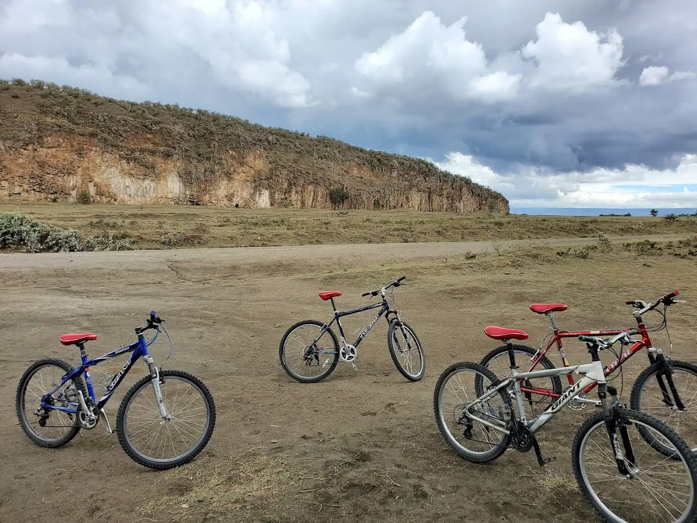 Mountain bikes in Hell’s Gate National Park with dramatic Rift Valley cliffs in the background