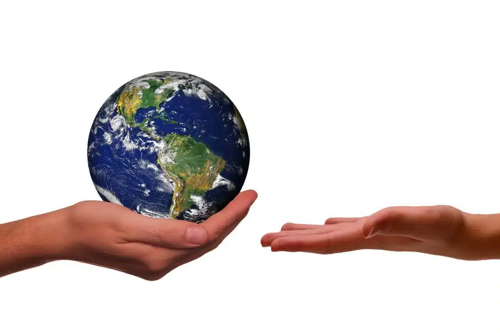 Hands holding the Earth symbolizing responsible tourism and ways to travel sustainably in Kenya