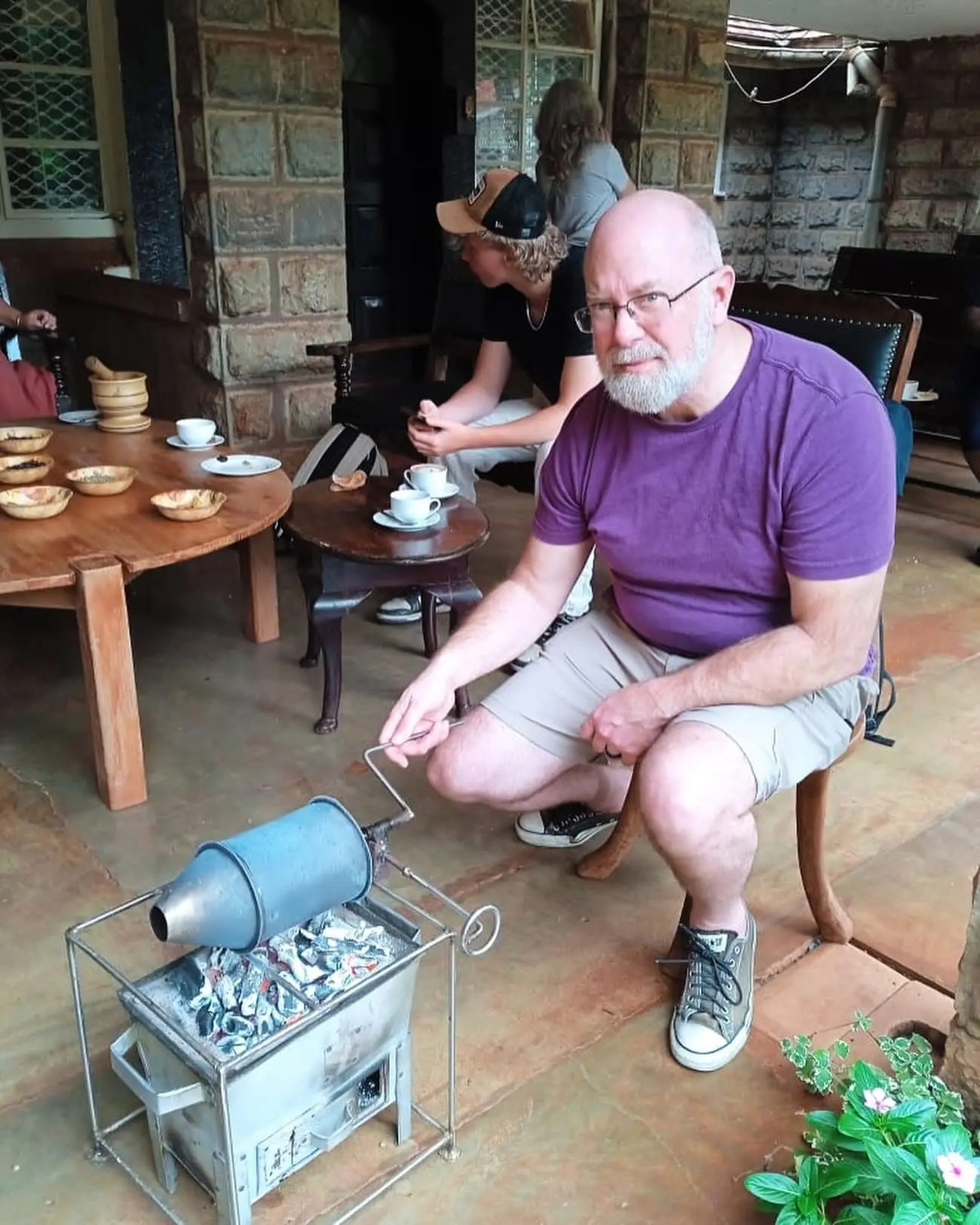 Traveller roasting coffee during a Karunguru Coffee Estate tour near Nairobi