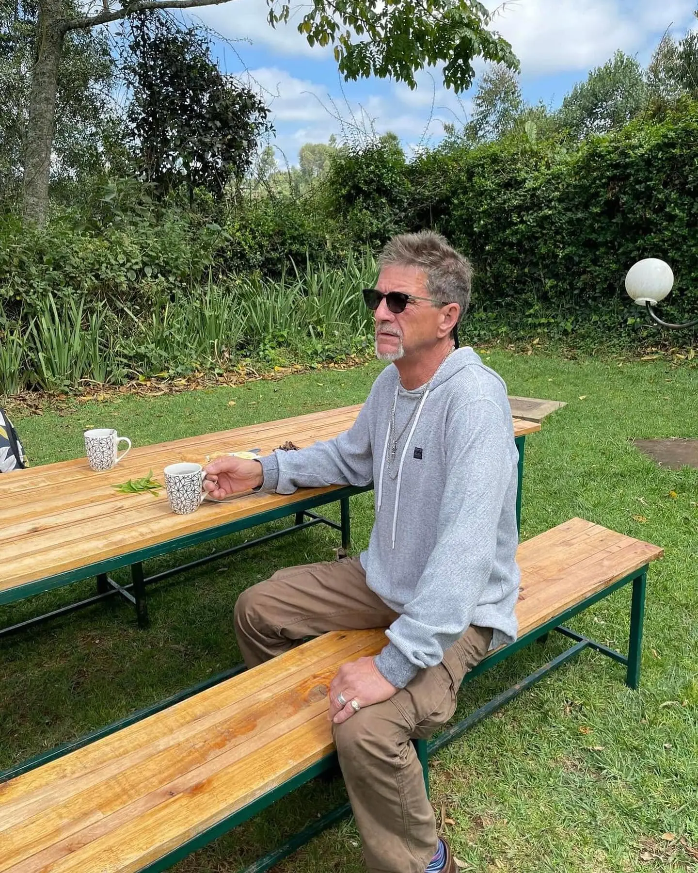Traveller enjoying tea in the garden at Gatura Greens in Kenya