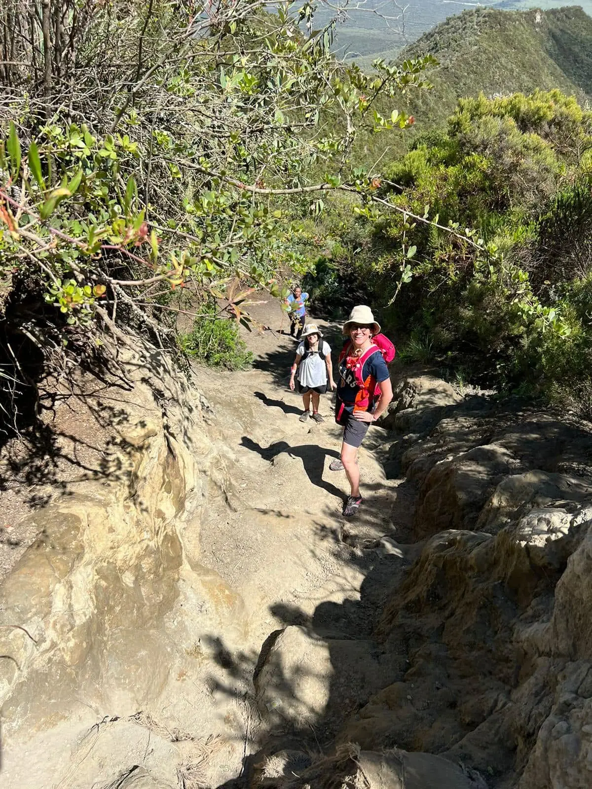 Hikers climbing a steep section of the Mount Longonot trail
