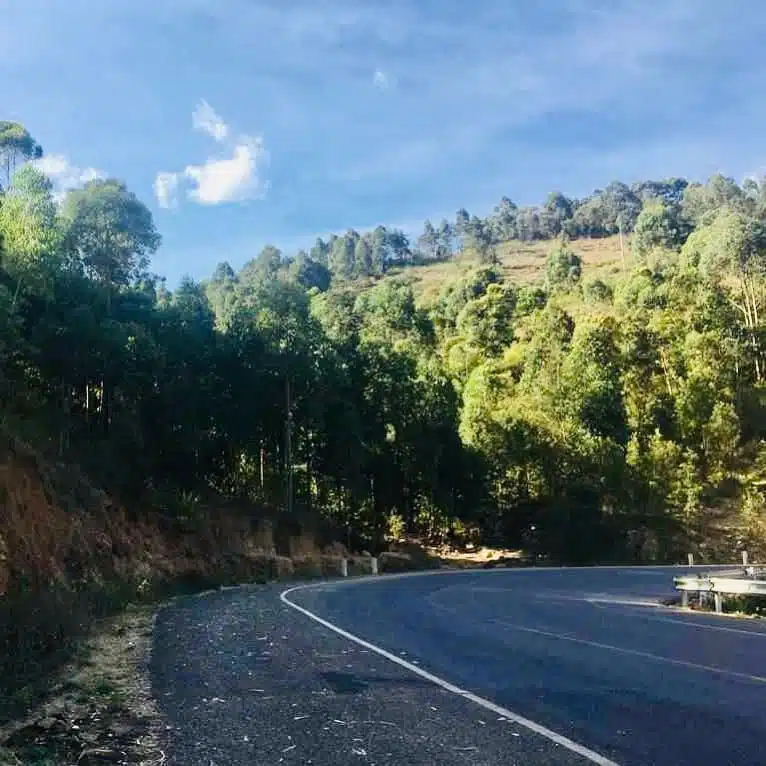 Scenic view of Kyamwilu Hill along the Machakos-Kangundo Road, with lush green hills and a winding road.