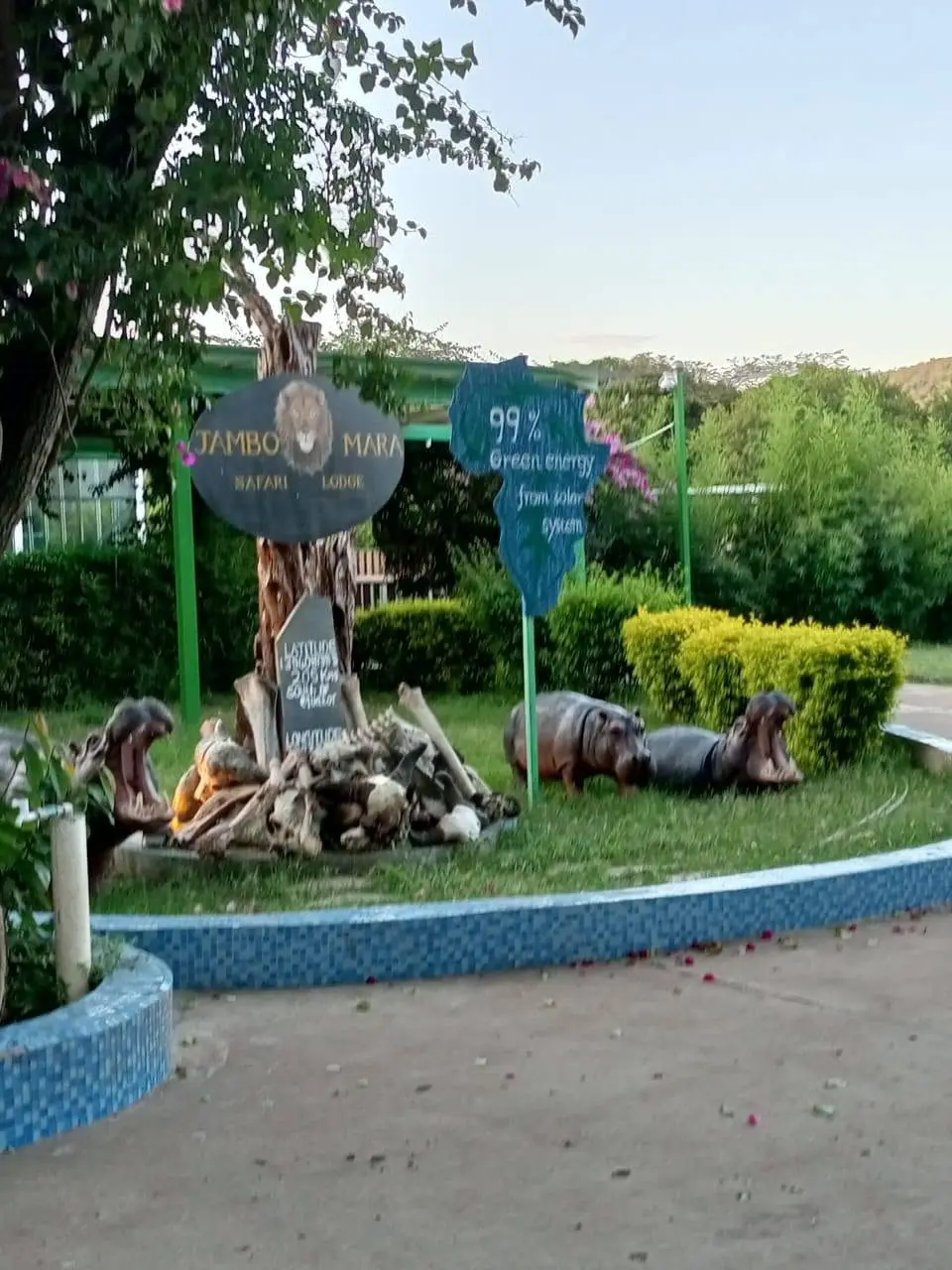 Entrance sign and landscaped grounds at Jambo Mara Safari Lodge