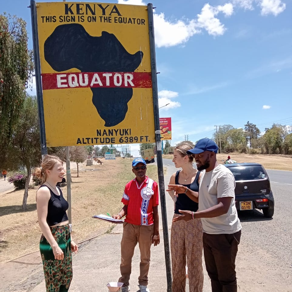 ravelers stopping at the Equator sign in Nanyuki, Kenya, en route to an Ol Pejeta safari