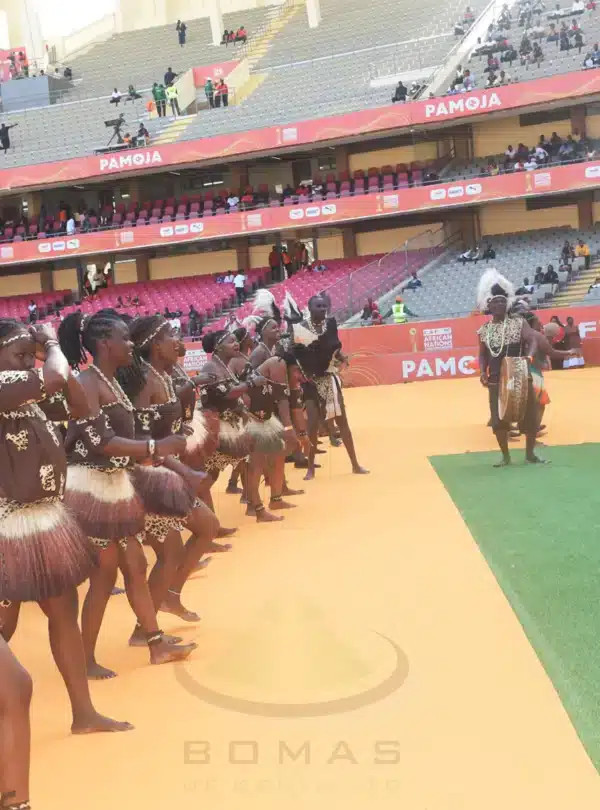 Traditional Kenyan dancers performing in colorful attire during a cultural showcase at Bomas of Kenya, Nairobi.