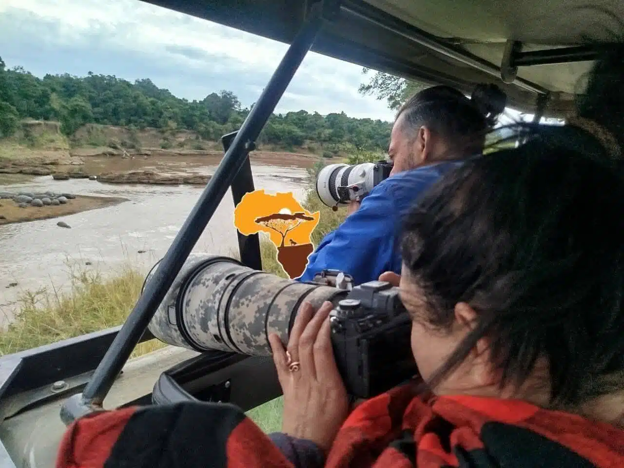 Wildlife photographers capturing river scenes on a private Kenya safari