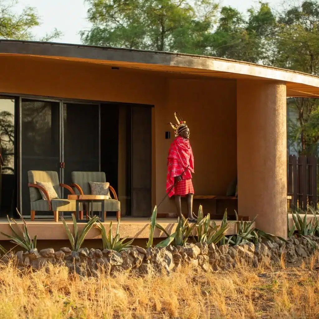 Samburu warrior standing outside a luxury tented suite at Soroi Samburu Lodge in northern Kenya