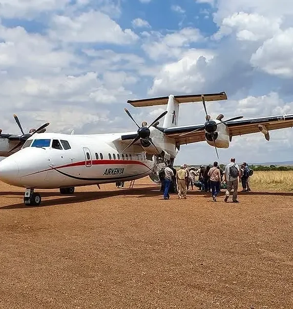 Passengers disembarking an AirKenya light aircraft on a remote airstrip in northern Kenya