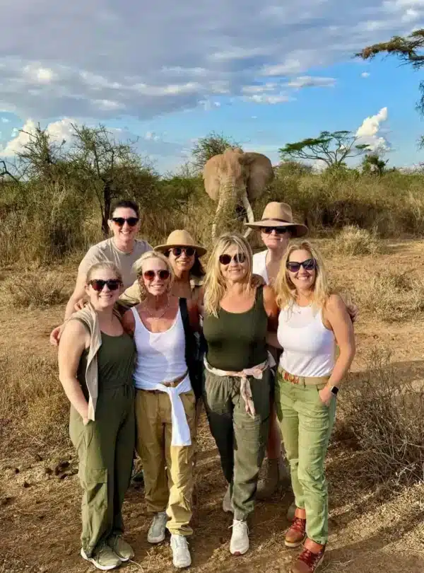 Group of travellers with an elephant in the background on a luxury Amboseli safari