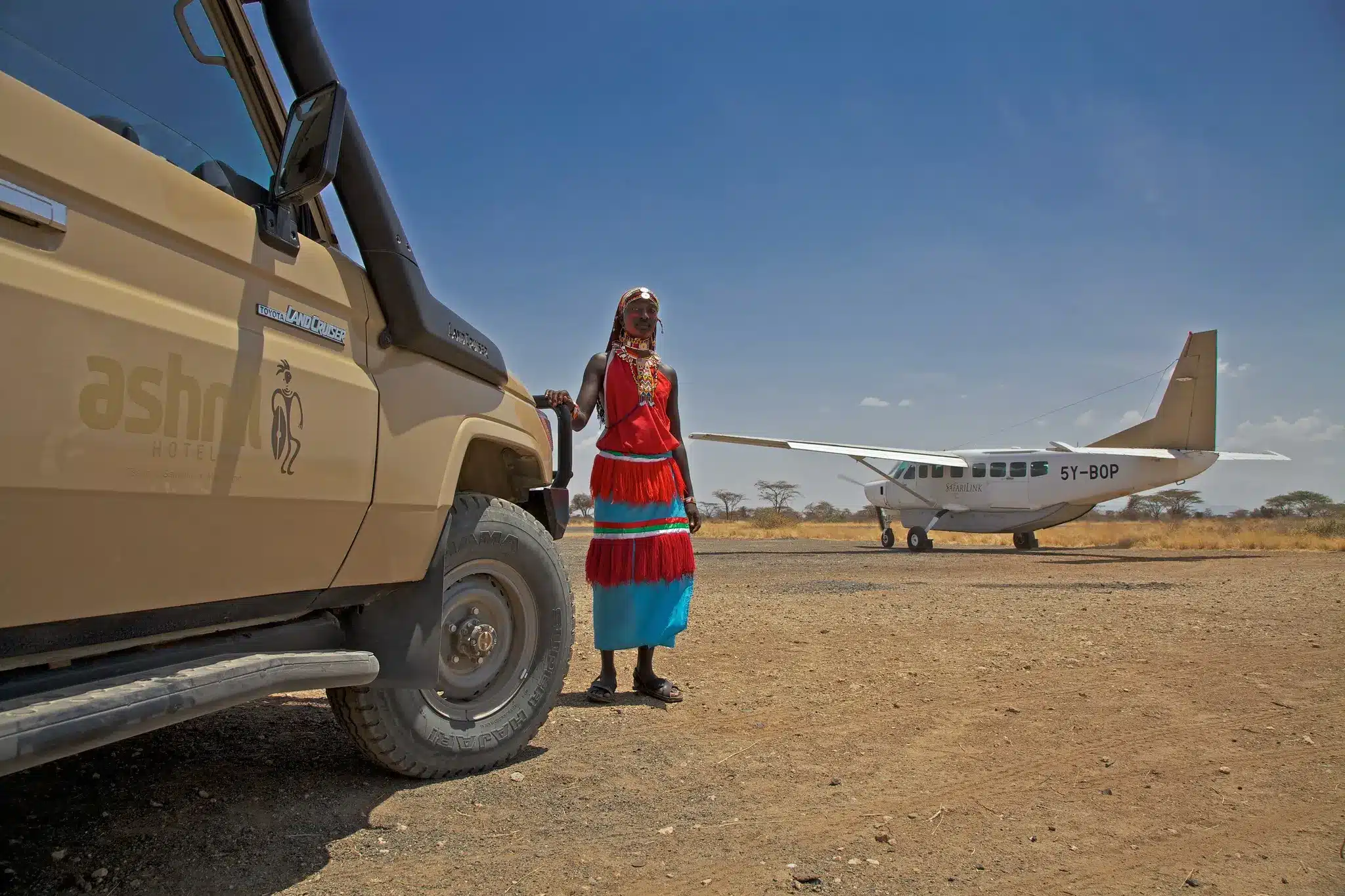 Light aircraft and safari cruiser at airstrip near Ashnil Samburu