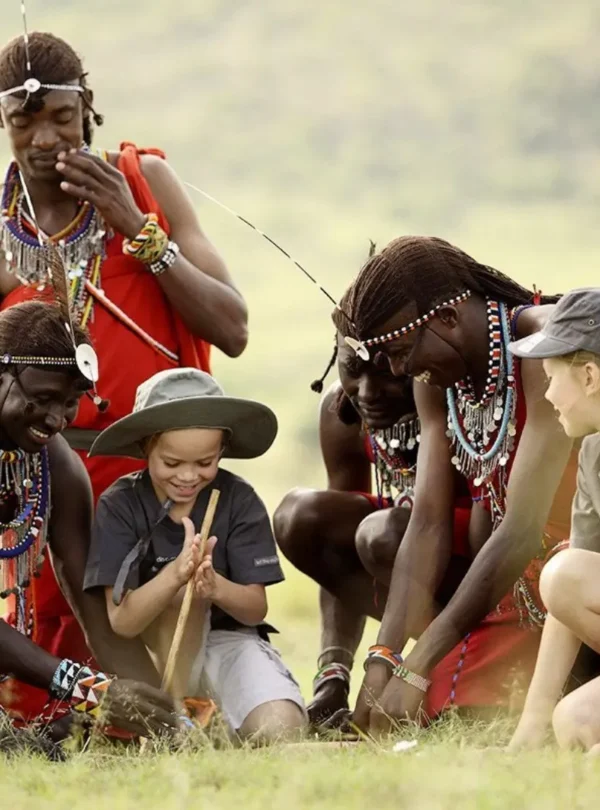 Children learning traditional skills during a Maasai cultural experience in Kenya.
