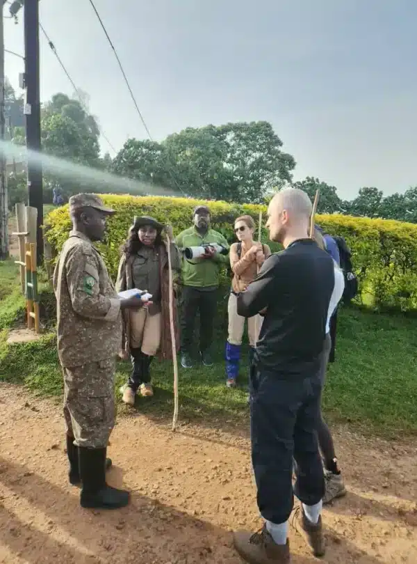 Uganda Wildlife Authority ranger briefing tourists before a gorilla trekking experience in Bwindi Impenetrable Forest.