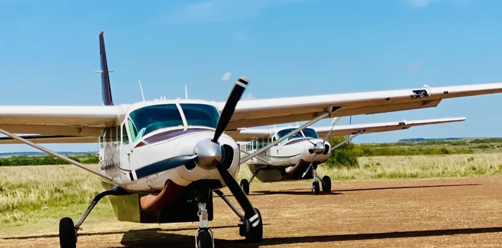Safarilink bush planes parked at Masai Mara airstrip for guest transfers