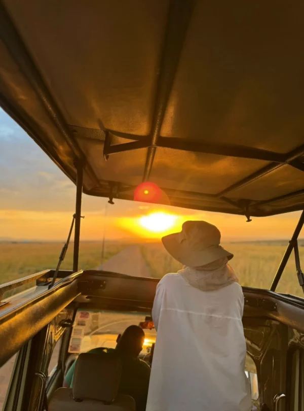 Guest viewing sunrise on a 10-day Kenya safari in the Masai Mara.