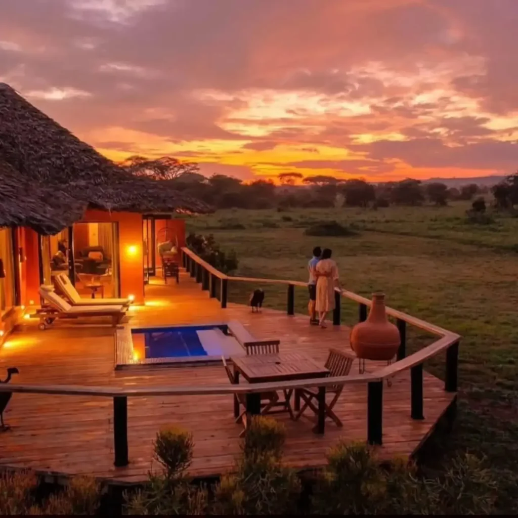 Luxury safari lodge terrace overlooking the savannah at sunset in Kenya