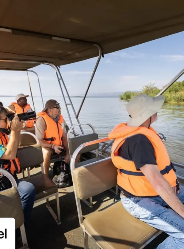 Boat safari on Lake Ihema in Akagera National Park with travelers observing wildlife.