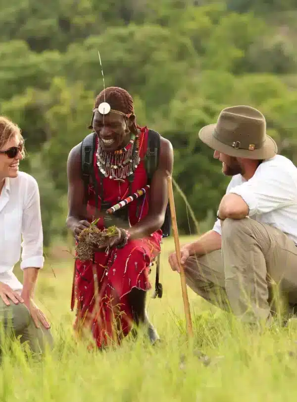 Safari travelers with a Maasai guide during a cultural experience on a Kenya safari