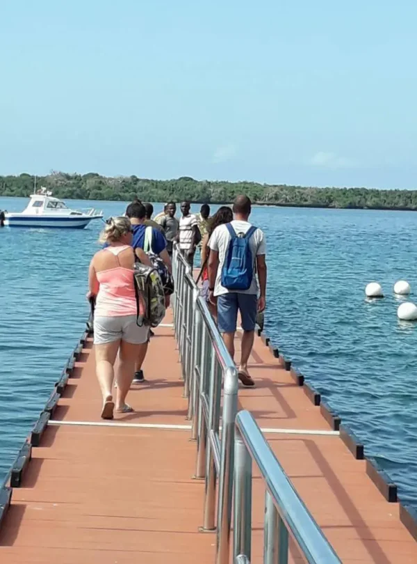 Guests boarding boats for a Kisite Mpunguti marine excursion from Diani, a common Coast add-on to Kenya safaris.