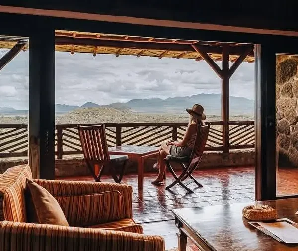 Guest relaxing on the terrace at Voi Safari Lodge overlooking Tsavo East