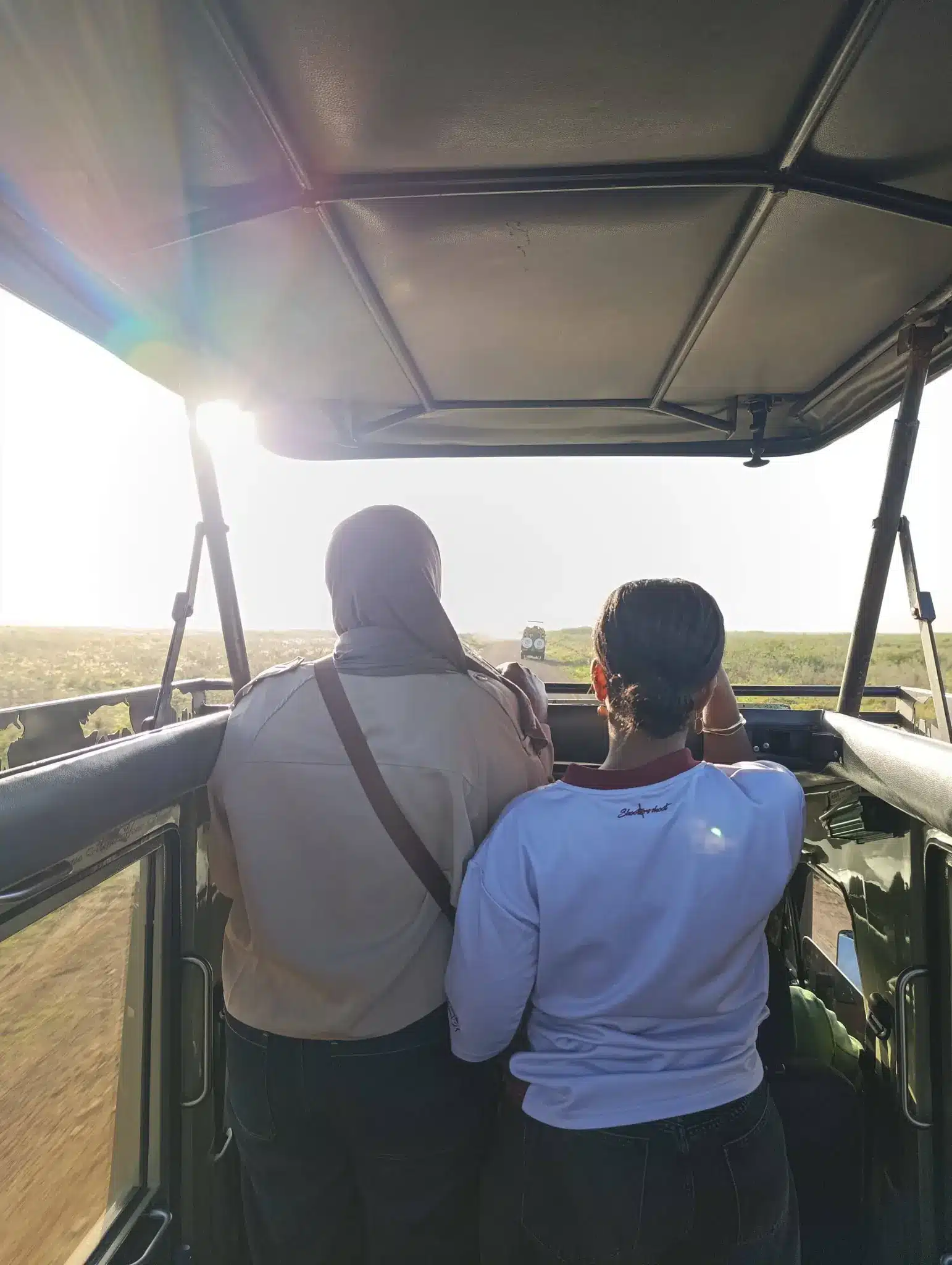 travelers on safari game drive in nairobi national park kenya near city skyline