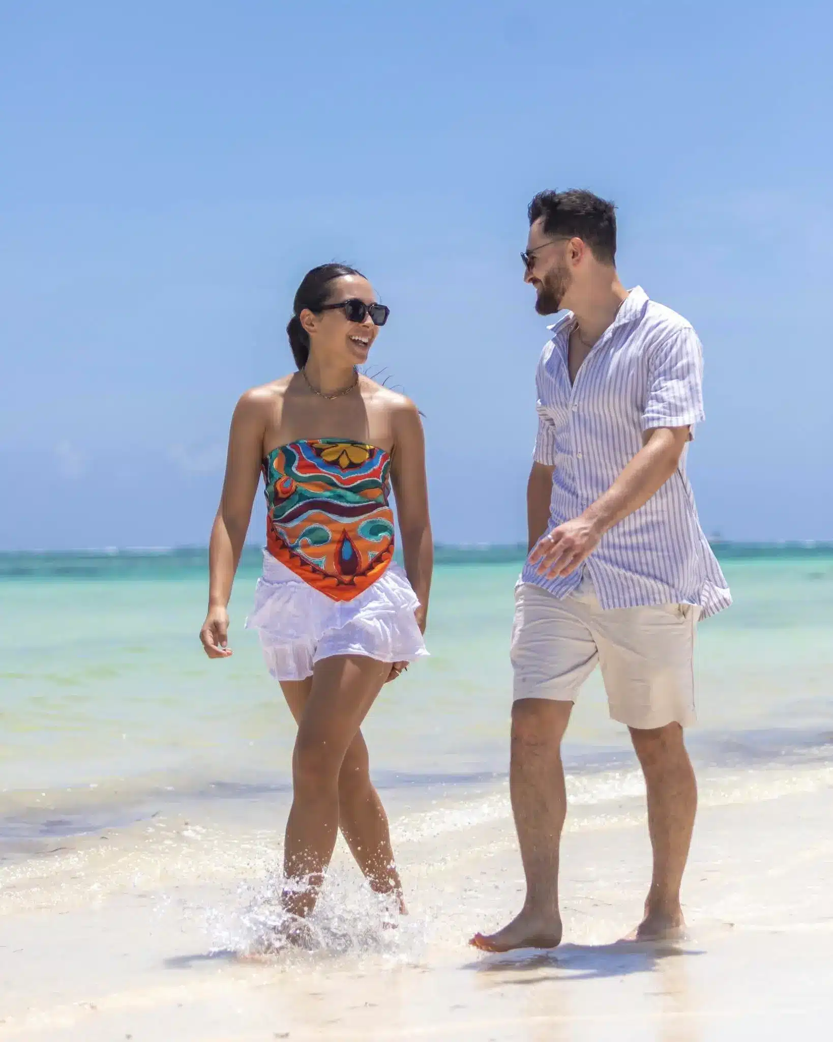 Couple enjoying a romantic beach walk on Chale Island during a luxury Kenya honeymoon safari