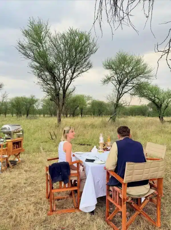 Couple enjoying a private bush dinner during an East Africa honeymoon safari